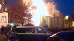 Fire crews tackle blaze at sports shop and flats