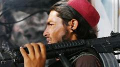 A Taliban fighter walks past a beauty salon carrying an M16 weapon.
