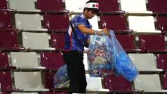 A Japan fan holding bags full of rubbish