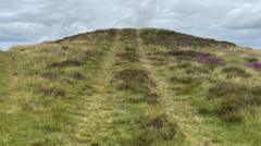 Tyre tracks on 4,000 year old Bronze Age burial mound after vehicle drives over it