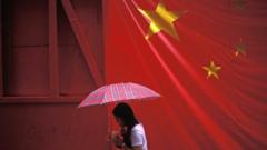 A woman with an umbrella walking under the Chinese flag