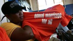 Lesbian for South Africa show off her shirt