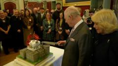 King Charles cuts his birthday cake during Wales visit