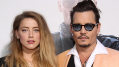 Actors Amber Heard and Johnny Depp attend the Boston premiere of "Black Mass"