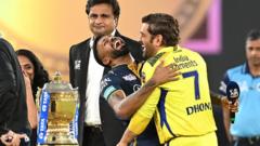 Chennai Super Kings' captain Mahendra Singh Dhoni (R) and his Gujarat Titans' counterpart Hardik Pandya laugh during the toss before the start of IPL final