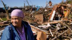 Clema Smith, who was trapped in the rubble, stands in front of the wreckage of her home in Wynne, Arkansas