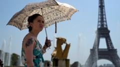 A woman cools down at the fountains of Trocadero, across from the Eiffel Tower, during a heatwave in Paris, France,