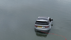 Images capture stranded Land Rover submerged in sea off beach