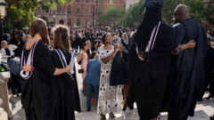 Woman wey dey snap her Masters graduating pikins