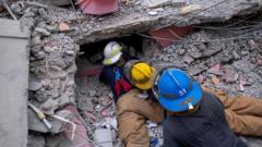 Haitian firefighters search for survivors, under the rubble of a destroyed hotel, in Les Cayes