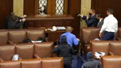 Capitol police officers point their guns at a door that was vandalized in the House Chamber during a joint session of Congress on 6 January 2021 in Washington, DC.