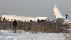 Emergency and security personnel are seen at the site of a plane crash near Almaty, Kazakhstan, December 27, 2019