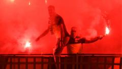 Football fans with lit flares
