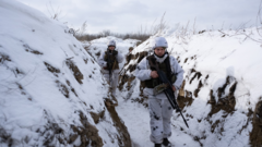 Ukrainian soldiers in a trench in winter, with deep snow on the ground