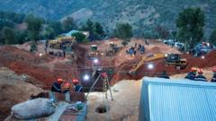 Rescuers dug a huge hole next to the well (front, centre)
