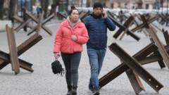 Couple walking through anti-tank barriers in Odesa