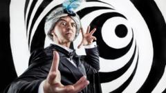 A man dressed as a magician performing a hypnotising trick