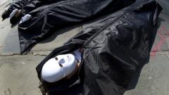 Protesters lay on the sidewalk in body bags near the United Nations in New York