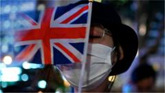 A masked Hong Kong activist holds the Union Jack in front of their face during 2019 pro-democracy protests in Hong Kong