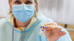 A medical worker holds a vial of the AstraZeneca vaccine against the coronavirus (Covid-19) in Ventspils, Latvia, on March 30, 2021