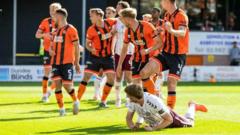 Man charged after Hearts player struck by lighter