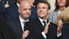 Fifa president Gianni Infantino (left) puts his hand on the arm of French president Emmanuel Macron (right)