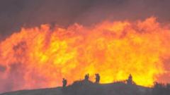 As winds pick up, LA firefighters desperately battle to contain monster inferno