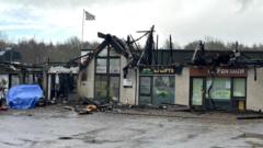 Fire-hit shops demolished as police probe continues