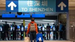 A traveler walks towards Shenzhen in the border control area at MTR Corp. Lo Wu station in Hong Kong, China, on Monday, Feb. 6, 2023.