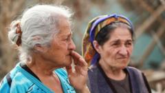 Women by destroyed house in Azerbaijan