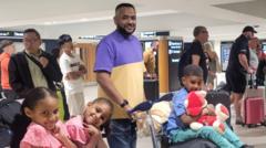 Ahmed Al-Doush at an airport with three of his four children