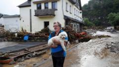 A man and his dog look at the damage caused by flooding in Germany, July 2021