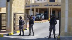 Gendarmerie officers stand guard at the gate of the new Salt government hospital in Jordan, 13 March 2021