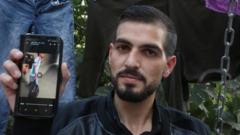 Qawasmi displays on his phone a video leaked online apparently showing a border guard shooting him in the back