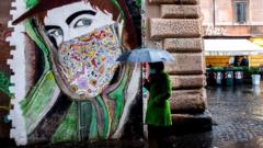 A woman wearing a face mask walks past a mural in Rome's Trastevere district