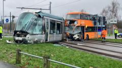 Passengers hurt as tram derailed in bus crash  