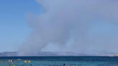 Two dead and evacuation under way as fires break out on Greek island