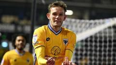 Dons midfielder Maycock signs two-year extension