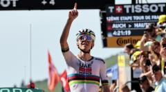 Tadej Pogacar points to the sky after winning stage 12 of the 2025 Tour de France