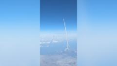 Passengers watch Artemis II blast off from commercial plane