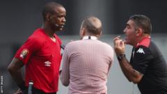 Tunisian backroom staff remonstrate with referee Janny Sikazwe