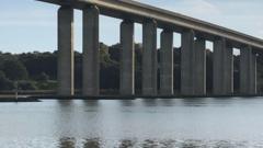 A view of underneath Orwell Bridge. The River Orwell can be seen passing underneath it.