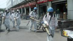 Volunteers from Blue Sky Rescue team in protective suits disinfect the Yuegezhuang wholesale market,