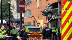 Injuries after van left dangling from car park