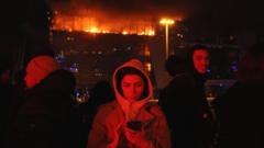 People are seen outside the burning Crocus City Hall concert hall following the shooting incident in Krasnogorsk, outside Moscow