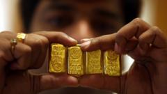 A salesman holds gold bars (file photo)