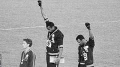 The iconic image of Tommie Smith (centre) and John Carlos (right) with black-gloved fists raised on the podium at the 1968 Olympic Games in Mexico City
