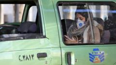A woman wearing a face mask in the back of a taxi in Tehran, 2 March 2020