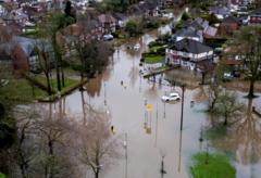 Homes flooded and weather warnings in place as wind and rain batter parts of UK