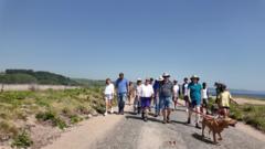 Hundreds march in support of coastal road repair